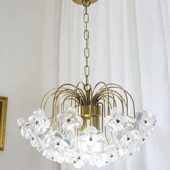 Close-up of the clear glass floral details on a gold-tone chandelier.