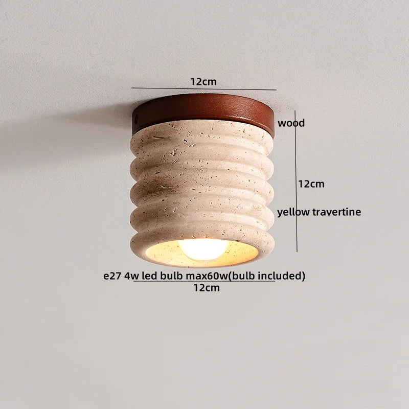 Detailed shot of a yellow travertine flush mount light with dimensions and material callouts: 12cm diameter, 12cm height, wood canopy, yellow travertine body, E27 bulb.