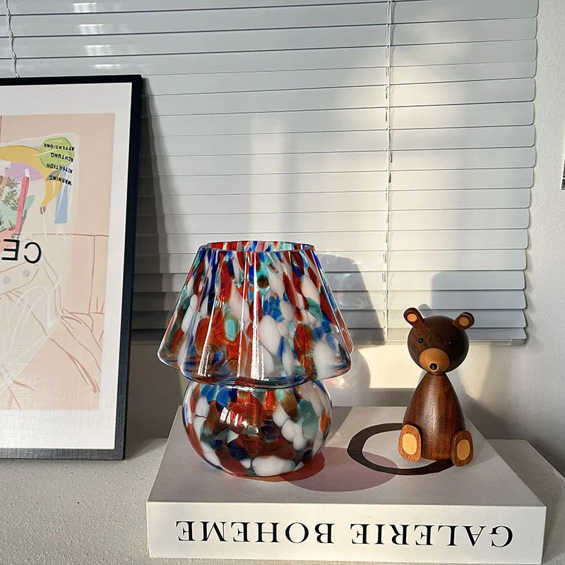 Colorful lamp with a wooden bear figurine on a surface with 'Galerie Boheme' branding.