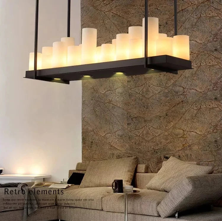 Modern living room with a stylish chandelier and textured wall.