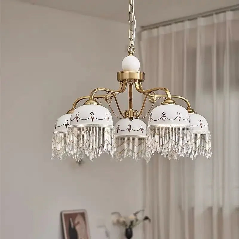 Side view of the gold floral ceramic pendant light, showcasing its structure and hanging chain.