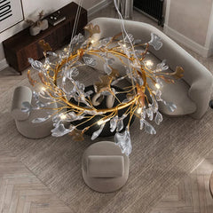 Overhead view of the gold leaf crystal chandelier illuminating a living room.