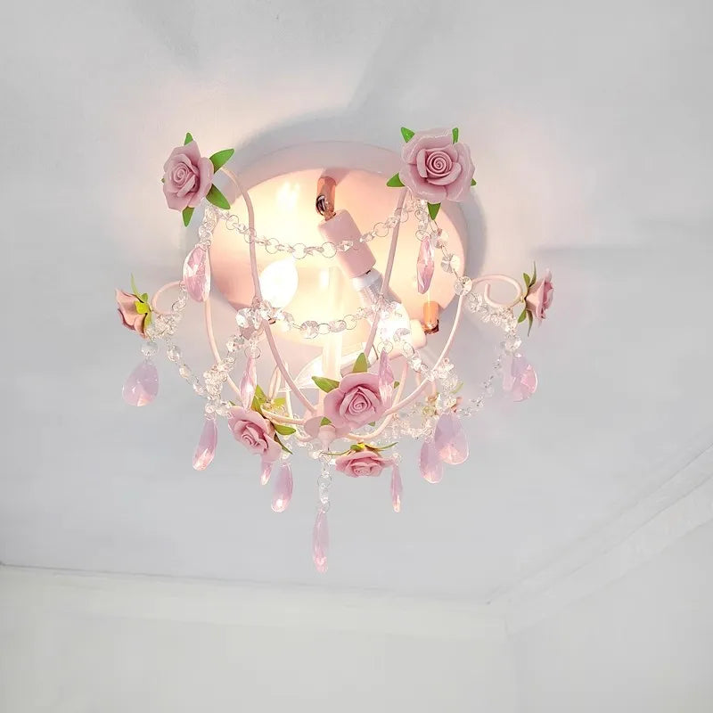 Side view of a pink rose bouquet semi-flush ceiling light adorned with pink ceramic roses and clear crystal droplets.