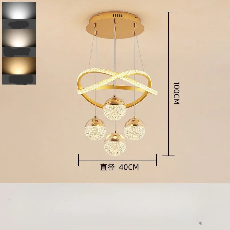 Modern pendant light with gold finish and crystal balls on a beige background
