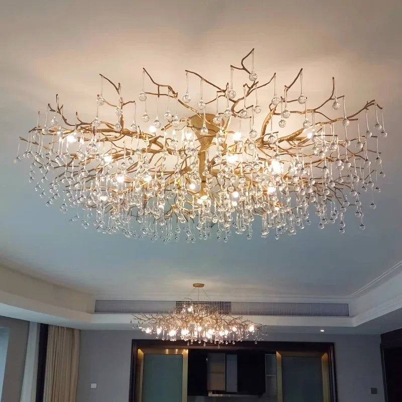 Close-up of the gold branch chandelier structure with numerous hanging clear crystals.