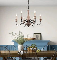 Dining room with a chandelier, table, chairs, and decorative elements.