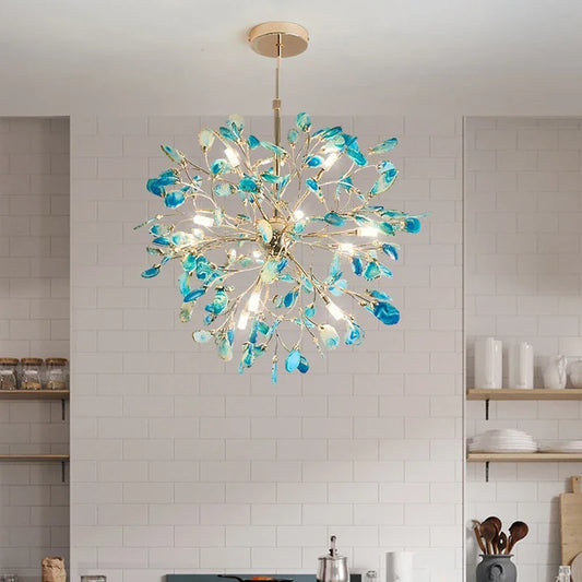 A blue agate slice floral chandelier with a gold frame hanging in a kitchen setting.