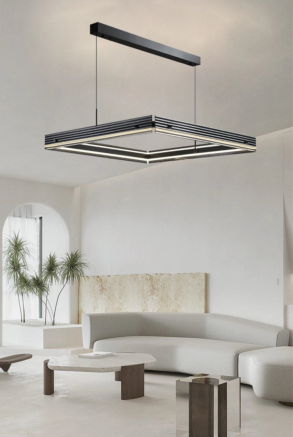 Modern chandelier hanging in a living room with a neutral color palette