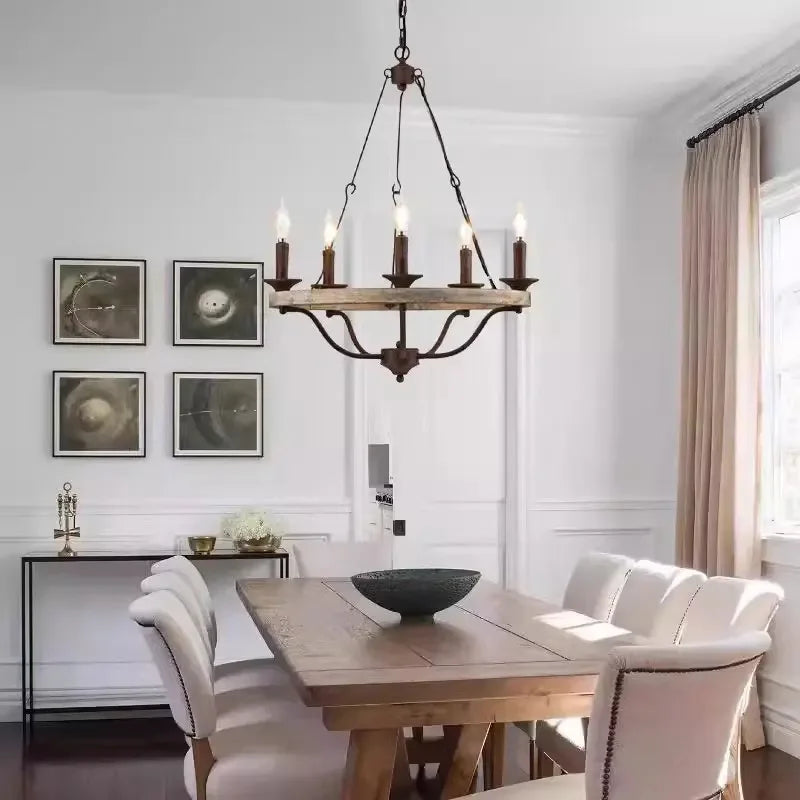 Dining room with wooden table, chairs, and a chandelier.