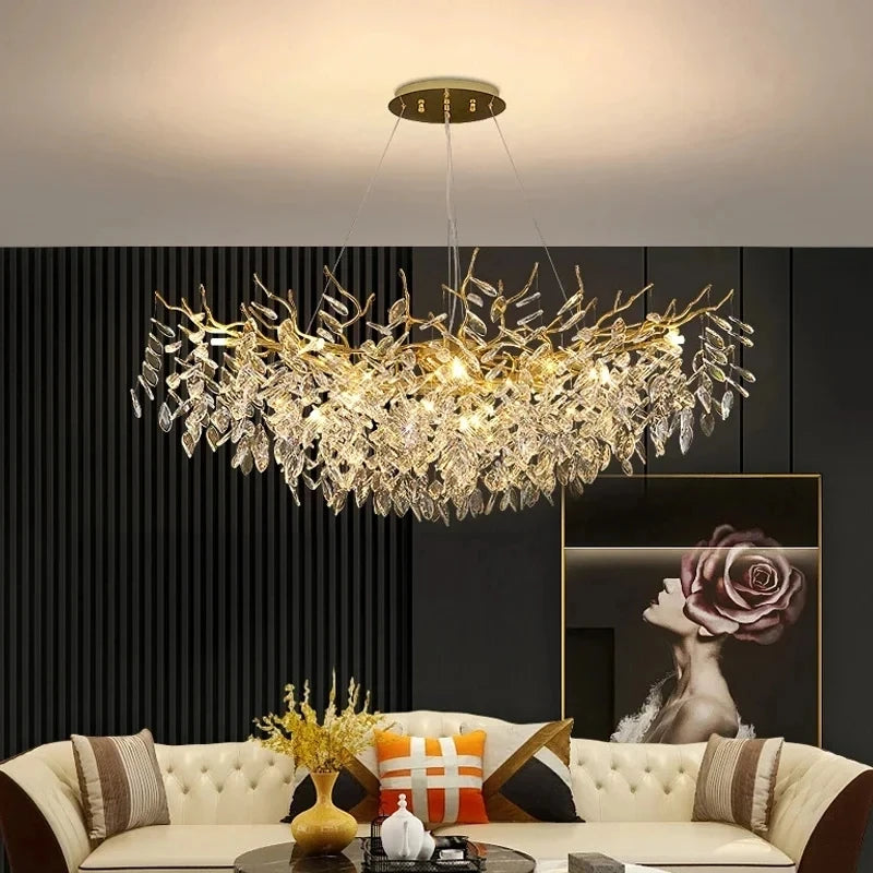 A wide shot of a living room featuring a gold crystal branch chandelier hanging above a sofa.