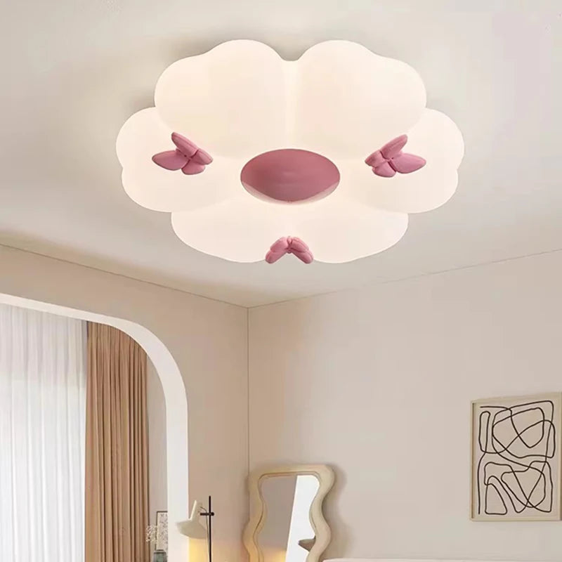 Close-up of a white flower cloud semi-flush mount ceiling light with pink butterflies, showing the center detail.