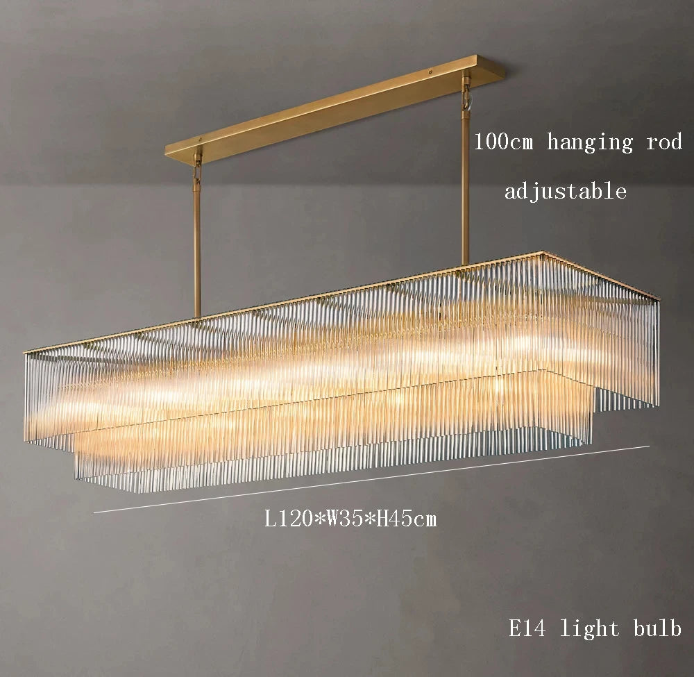 Modern rectangular chandelier with gold frame and clear glass on a gray background