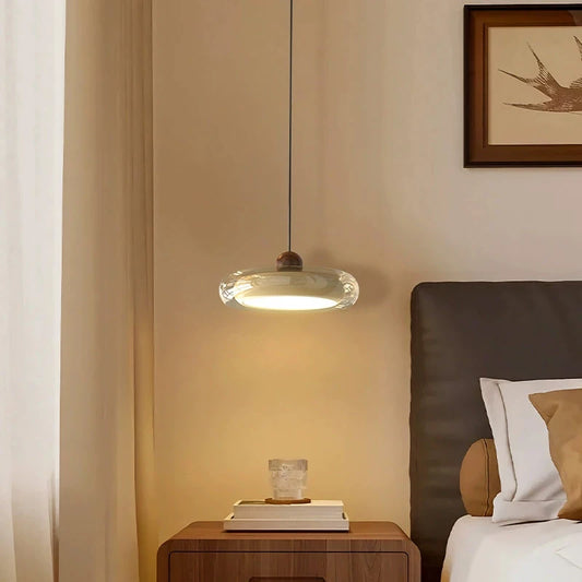 Side profile of the blue oval pendant light with red accent, highlighting its sleek shape.
