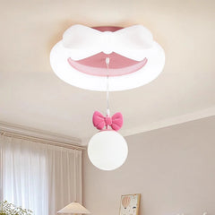 A child's bedroom with the white and pink bow ceiling light installed, casting a soft glow.