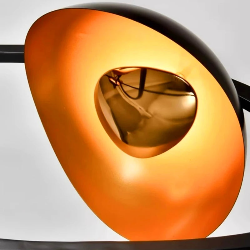 Close-up of a modern, abstract sculpture with orange and black colors.