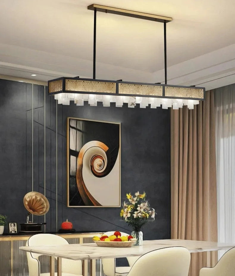 Modern pendant light fixture in a stylish interior setting with a dining table and abstract art.