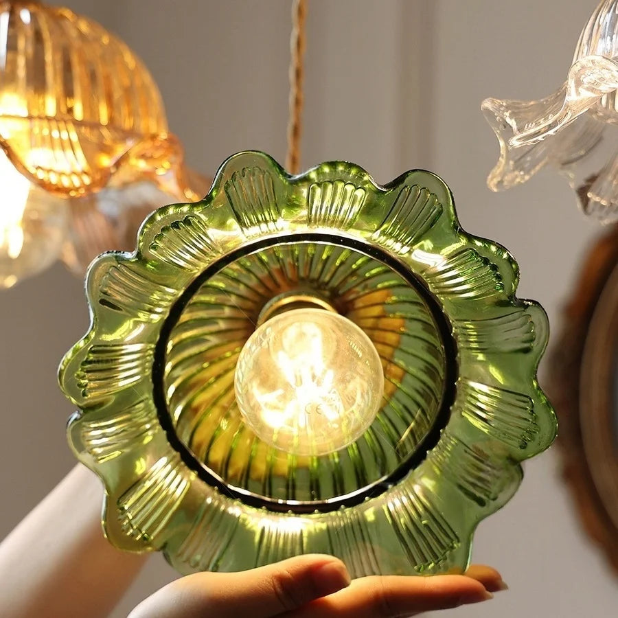 Close-up of a green glass light fixture with a blurred background