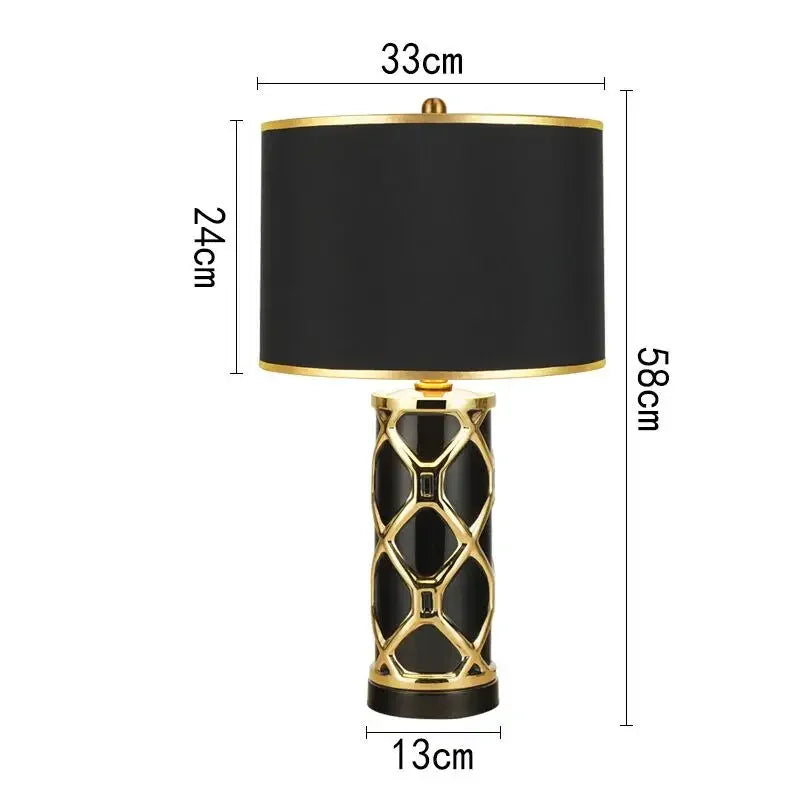Black table lamp with gold accents and measurements on a white background