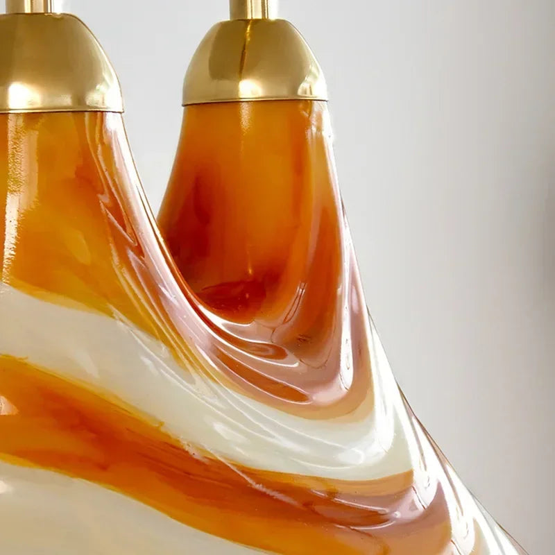Decorative lamp with gold top and multicolored base on a white background