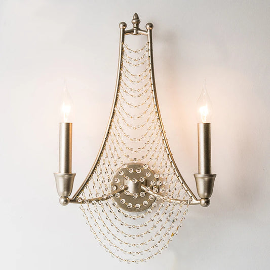 Silver metal wall sconce with two candle-style lights and cascading clear beads.