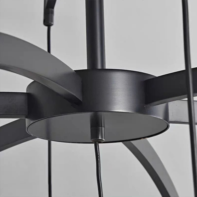 Close-up of a black ceiling fan against a gray background