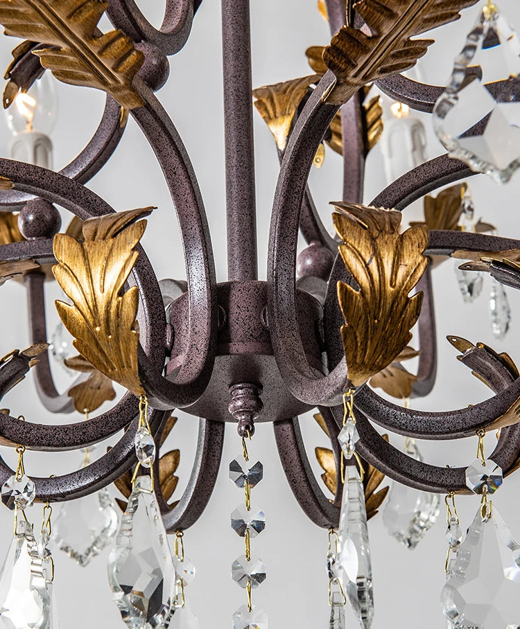 Close-up of a chandelier with decorative metalwork and crystal elements.