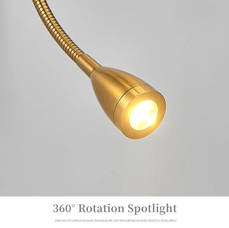 Gold spotlight with flexible neck on a gray background