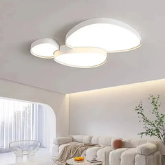 Side view of the white cloud-shaped LED semi-flush mount ceiling light in a well-lit living space.