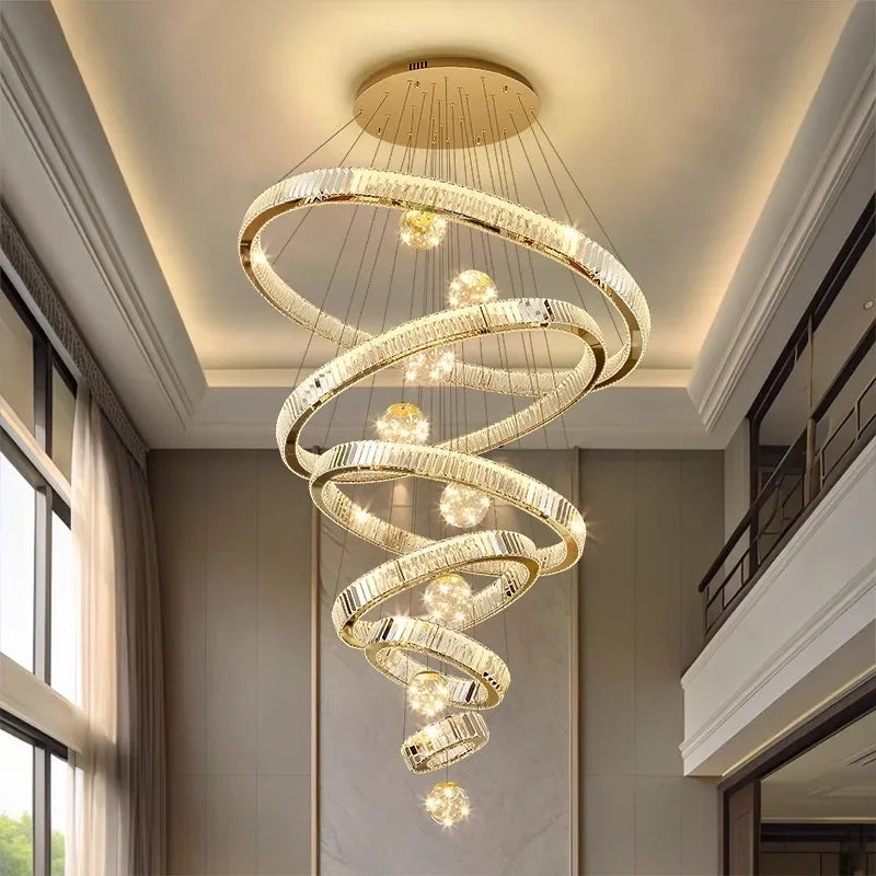 Modern chandelier with spiral design in a room with large windows.