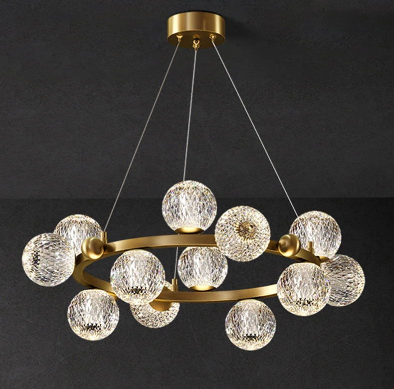 Chandelier with gold frame and clear glass balls on a black background
