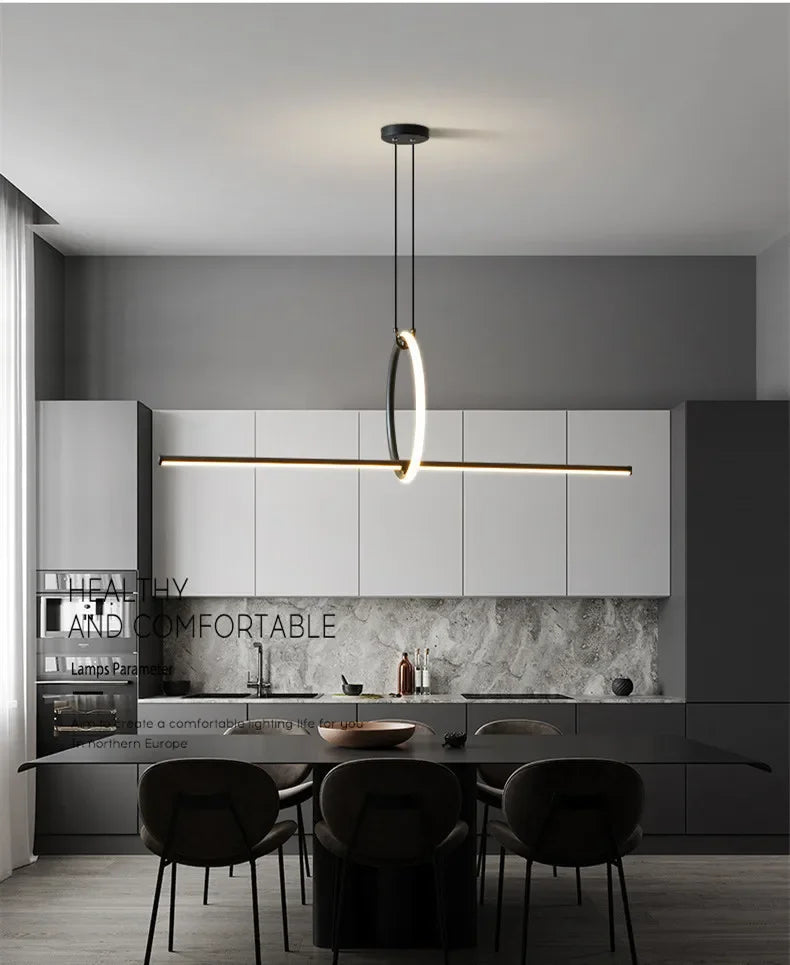 Modern kitchen with pendant light fixture, gray walls, and marble backsplash.