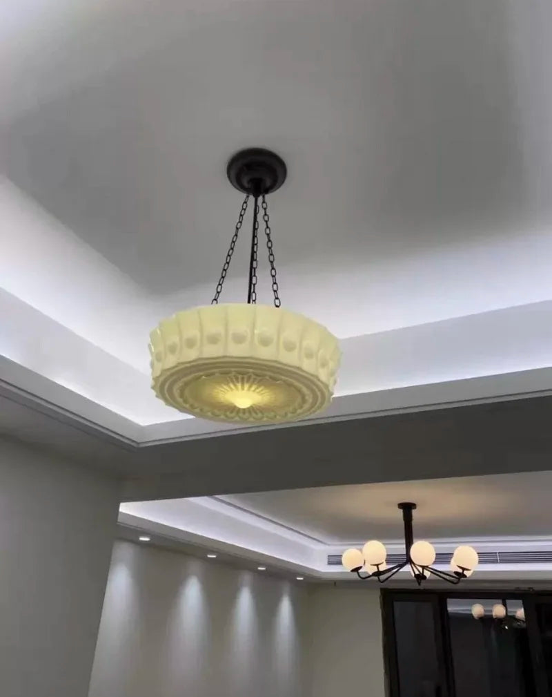 Decorative ceiling light fixture in a room with a modern design.