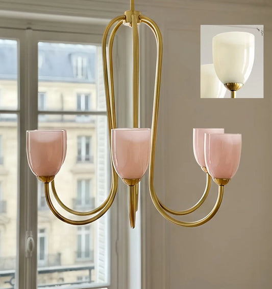 A gold-toned chandelier with five pink glass shades, viewed from a slightly different angle.
