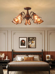 A semi-flush mount ceiling light with a brushed bronze finish and amber stained glass shades, seen from a slightly lower angle.