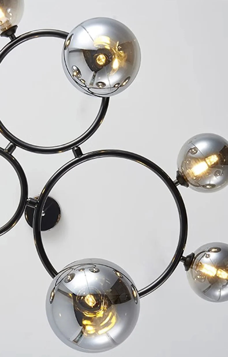 Modern chandelier with spherical metal lights on a white background