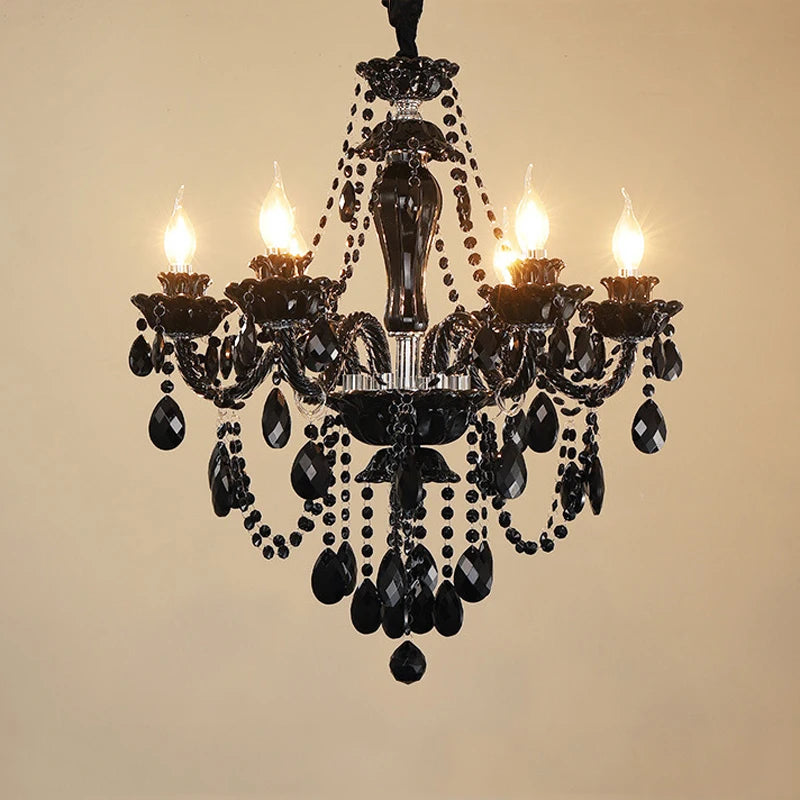 Close-up of the gold crystal chandelier, highlighting the intricate design of faceted crystals and polished metal arms.