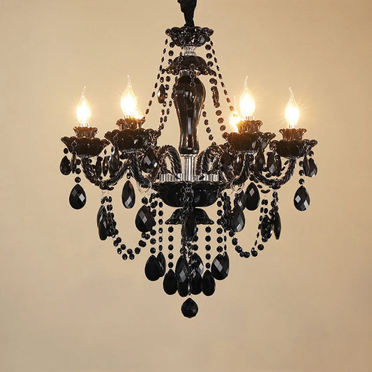 Close-up of the gold crystal chandelier, highlighting the intricate design of faceted crystals and polished metal arms.