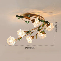 Overhead view of a gold floral semi-flush ceiling light with clear glass shades, illuminating a ceiling.