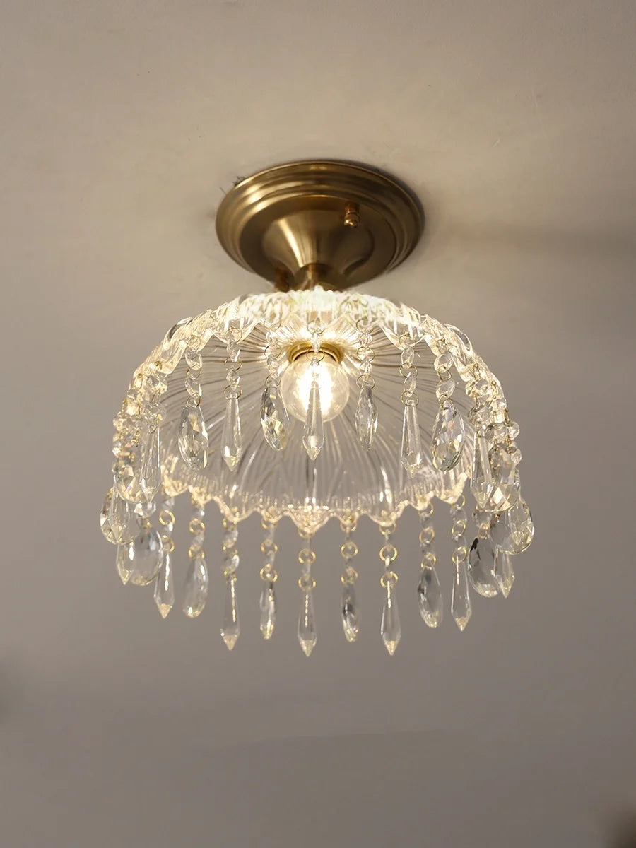 Chandelier light fixture with crystal details on a ceiling