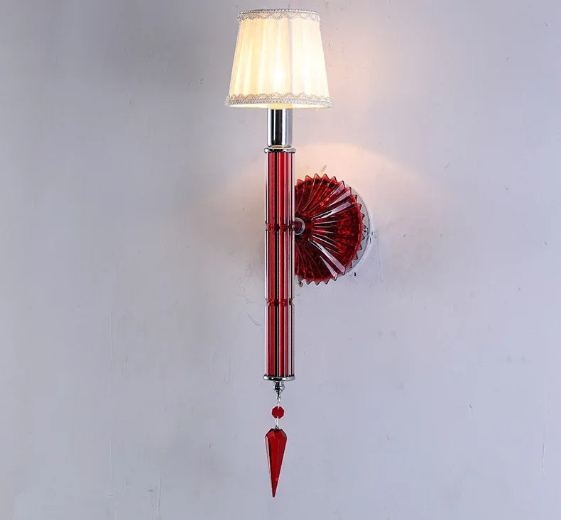 Decorative wall lamp with red glass and white shade on a light gray background