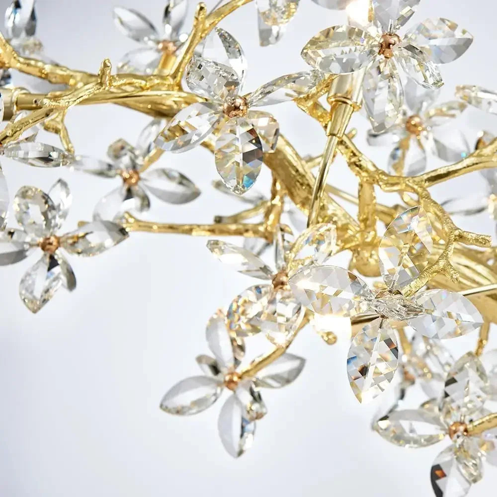 Close-up of a decorative item with gold and clear crystal elements on a light gray background