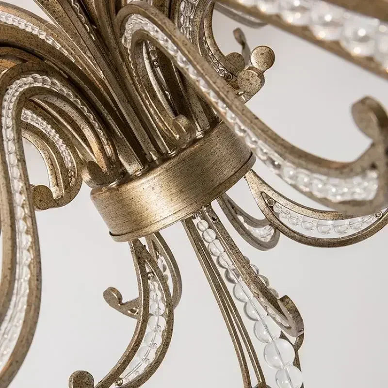 Close-up of an ornate chandelier with intricate details on a white background
