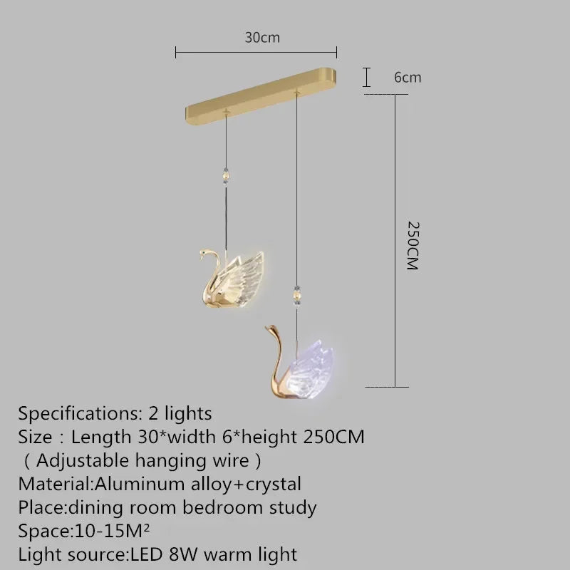 Gold swan-shaped pendant light with dimensions on a gray background