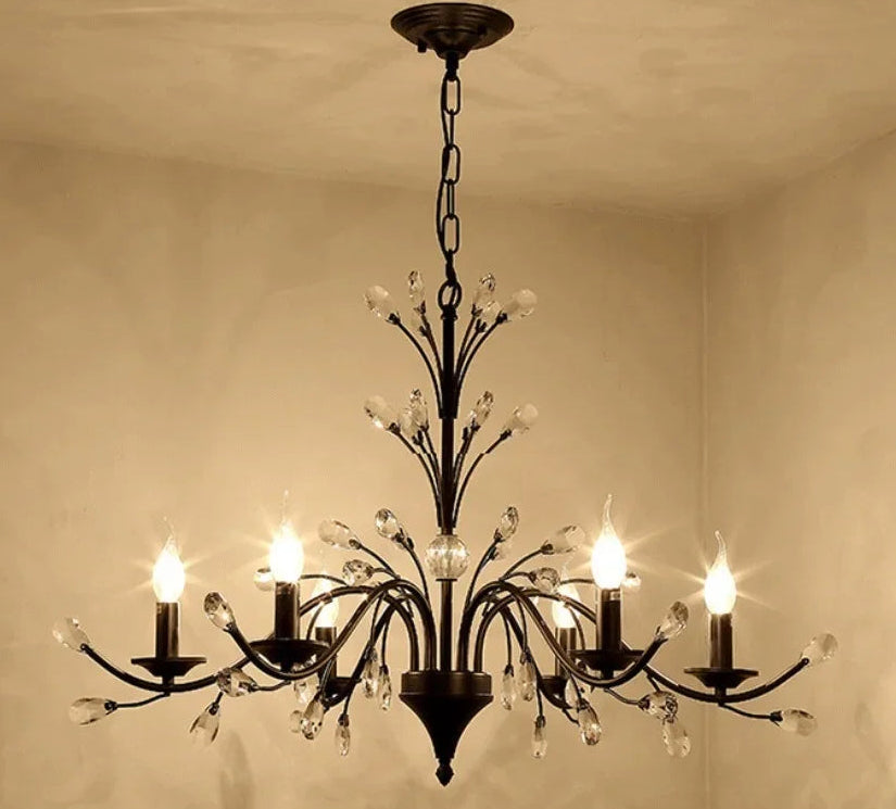 Decorative chandelier hanging from a ceiling with a beige wall background
