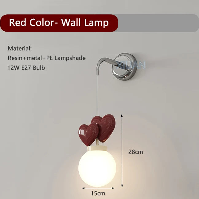 Red color wall lamp with heart-shaped design on a white background