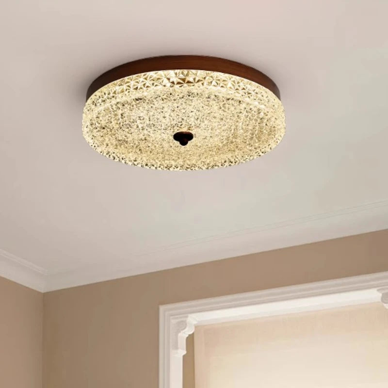 Ceiling light fixture in a room with beige walls and a white window frame.