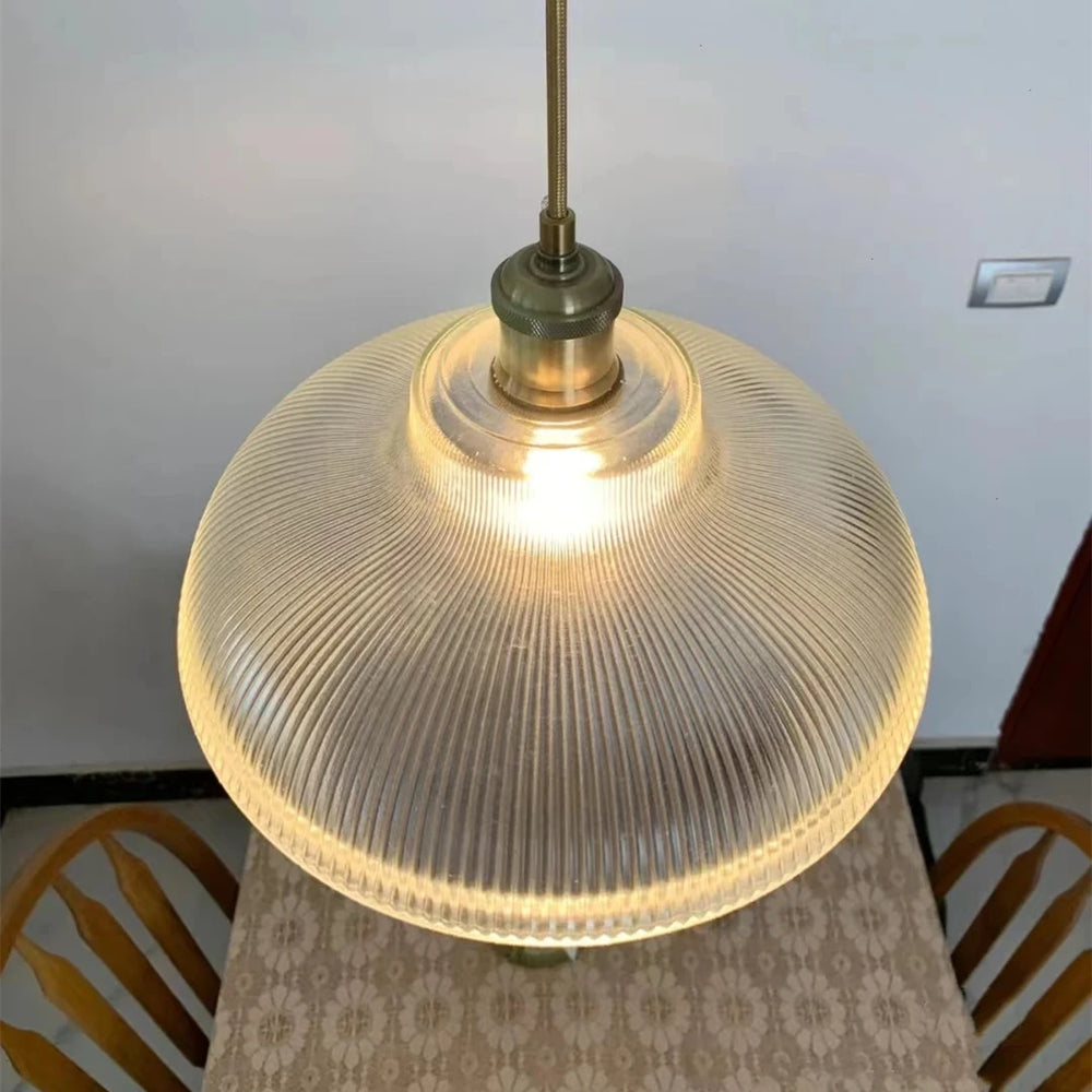 Glass pendant light with ribbed design on a neutral background