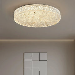 Round gold textured resin flush mount ceiling light illuminating a room
