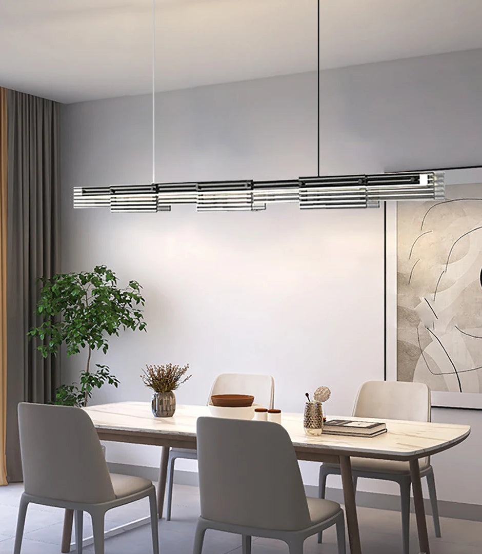 Modern dining room with a chandelier, table, chairs, and decor.