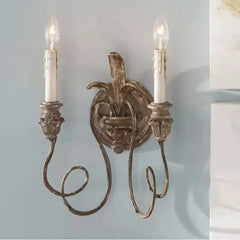 Decorative wall sconce with two candles on a light blue background